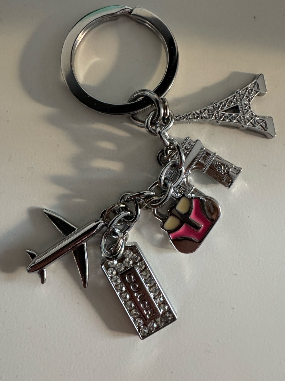 COACH Silver-Tone Paris Travel Charm Keychain with Pink Accent